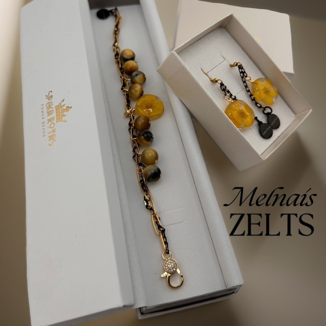 melnais zelts Aproce "Melnais zelts” ar zeltainu gundegas ziediņu. – Spēka Rotas